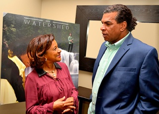 Jamaica's honorary Consul to Georgia, Mrs. Jewel Scott, congratulates Jack Radics at the launch of his new album, “The Watershed.” 