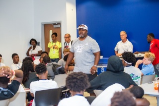 Pictured center: Donnell Bennett, former running back at the University of Miami and the NFL’s Kansas City Chiefs, addresses student-athletes participating in the Florida vs. Georgia Future Starts Game about character and the keys to success as part of a 