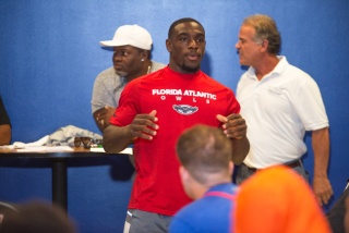 Pictured center: Gerald Hearns, the starting running back with the Florida Atlantic University football team, mentors a group of student-athletes attending the Florida vs. Georgia Future Starts Game about perseverance and work ethic as part of a Student A