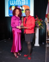 Ms. Anne McNeill (right) receiving the Trailblazing Women 2022 Award from Ms. Marie R. Gill 