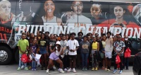TRIO UBMS students pose outside of their bus after a trip to iFly of Jacksonville