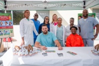 Jessie Trice Community Health System Dental Staff pictured with NFL players Zach Sieler from the Miami Dolphins (center left) and Tutu Atwell from Los Angeles Rams. Photo credit - Ricardo Reyes, Sonshine Communications