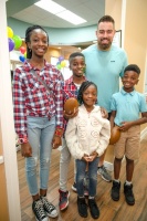 On Feb. 11, 2023, Jessie Trice Community Health System hosted the Give Kids A Smile Day. NFL player Zach Sieler a defensive end for the Miami Dolphins, pictured with some of the children who received dental care during the event held at the JTCHS—Corporat