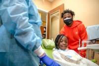 Chatarius “Tutu” Atwell, wide receiver for Los Angeles Rams, pictured with a patient during the Give Kids A Smile Day hosted by Jessie Trice Community Health System on Feb. 11.  Photo credit: Ricardo reyes, Sonshine Communications