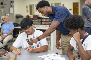 Jecory Ellis, Project Manager with NextEra Energy, assisted students from Palm Beach Lakes Community High School during a Generator Build Competition as part of an energy career workshop.