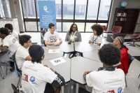 Whitney Walker, Lead Community Relations Specialist with NextEra Energy/FPL, interacts with students from Palm Beach Lakes Community High School as they prepare to participate in a Generator Build Competition.