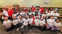 Stephen and Ayesha visiting with students from Madison Park Primary in their remodeled library during Christmas with the Currys on December 4, 2024. Credit: Eat. Learn. Play