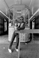 Dawoud Bey, A Boy in Front of the Loews 125th Street Movie Theater (from the series "Harlem U.S.A."), 1976. Silver print, 8 1/2 × 5 3/16 in. Studio Museum in Harlem; gift of the artist 1979.1.12 © Dawoud Bey